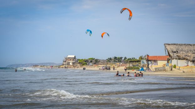 Mancora, Peru - April 18, 2019: Kitesurfers flying over the beaches of Mancora